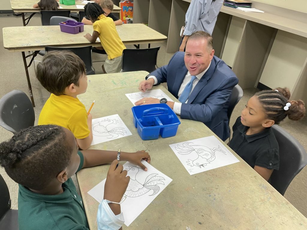 Superintendent Chris Neeley sits with South Carolina Elementary Students